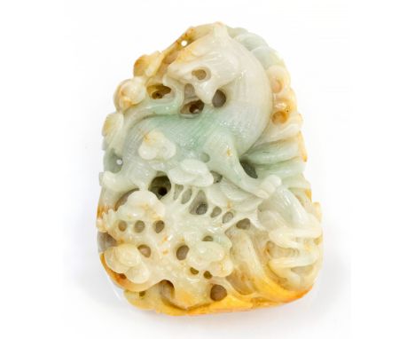 A Chinese carved jade pendant, a lion and bat within a fungal forest landscape, 8.5cm long