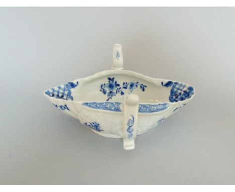 A Worcester two handled sauce boat with moulded decoration printed panels of Chinese scenes in underglaze blue, circa 1756-57