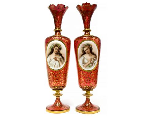 A pair of mid 19th Century ruby glass Bohemian portrait vases, opaque oval plaques painted with women in floral garlands and 