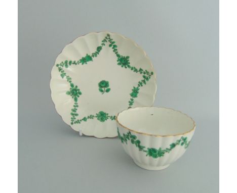 A rare fluted Worcester tea bowl and saucer, painted with green swags and outlined in black, circa 1770, tea bowl 8cm diamete