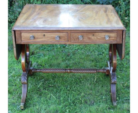 A William IV mahogany sofa table, the veneered top with a cross-banded edge, fitted with two drawers to front, raised on lyre