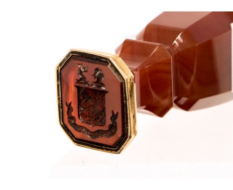 A Victorian agate handled desk wax seal, of canted baluster form, the agate matrix intaglio engraved with a heraldic crest ov