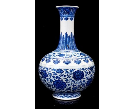 A Chinese blue and white floral bottle vase, Qianlong mark and of the period, ovoid form with elongated flared neck, the body