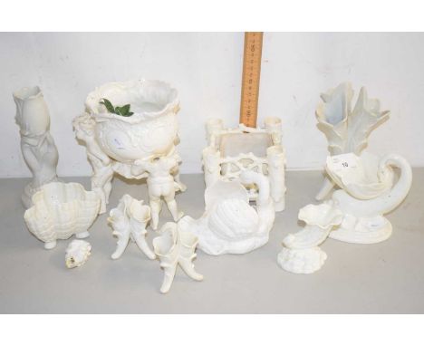 A group of cream glazed porcelain items to include small Worcester shell formed vases, vase with cherub decoration and other 