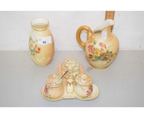 A group of blush Worcester wares comprising a cruet with stand, a gilt handled jug and a baluster vase, all appear in good co