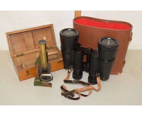 A vintage brass students microscope together with cased binoculars