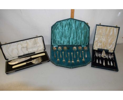 A cased pair of fish servers with ivorine handles, cased silver plated spoon and fork set and further cased plated cake forks