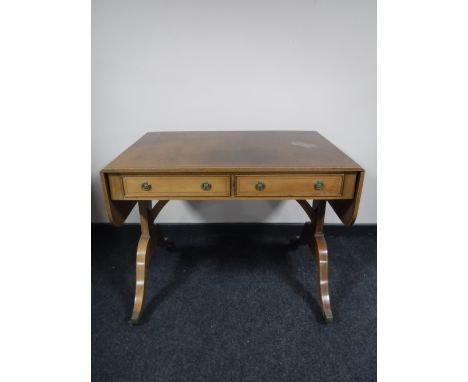 An inlaid mahogany Victorian style sofa table fitted two drawers