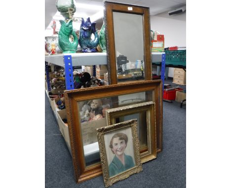 An early 20th century oak framed bevelled hall mirror together with an Edwardian oak frame, a gilt frame and a gilt framed oi