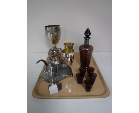 A small collection of silver plate, including three goblets, a sugar helmet with scoop and a teapot, together with a glass li