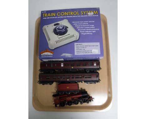 A Hornby 00 Gauge Hogwarts Express with two carriages and a Bachmann train control system 