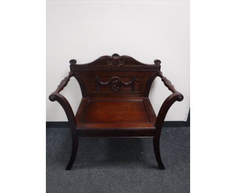 An Eastern mahogany carved armchair CONDITION REPORT: Typical light scuffs and scratches to frame but overall good condition.