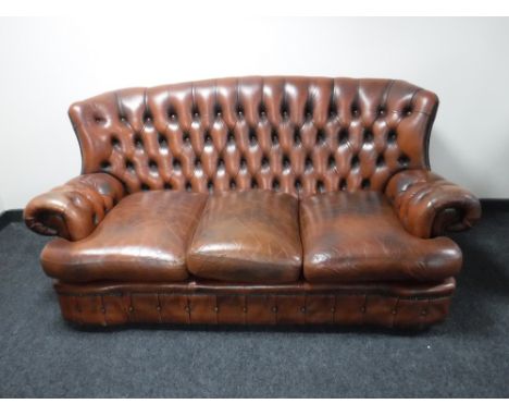 A brown button chesterfield three seater settee 