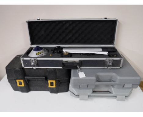 A cased B&Q laser level together with a cased Pro sander, a cased Black and Decker electric drill and a three in one tool set