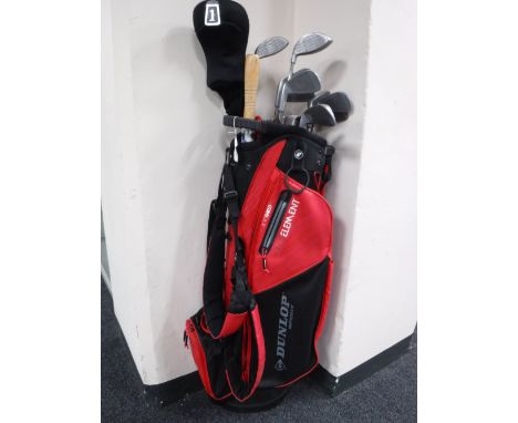 A Dunlop Sport gold bag containing a set of Peter Alice dual impact golf clubs