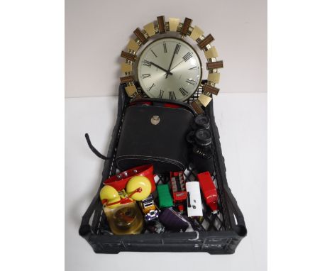 A basket containing a tin plate alarm clock, a desk clock, die cast vehicles, quartz Metamec wall clock, binoculars