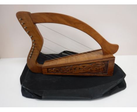 A twelve stringed Celtic harp in carry bag 