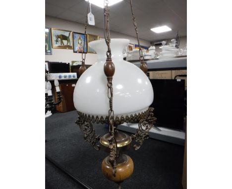 A continental chandelier in the form of an oil lamp with a glass chimney and shade