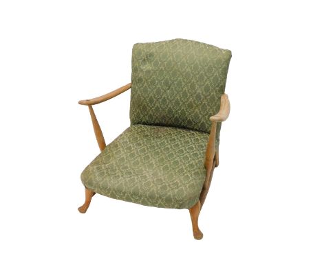 An Ercol type beech low open armchair, with a padded back and seat, on cabriole legs, with H stretcher. The upholstery in thi
