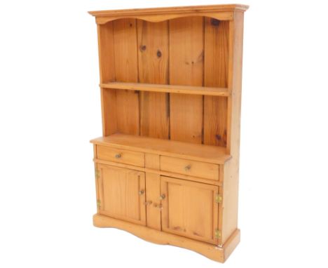 A miniature replica pine dresser, the back with a single shelf, the base with two short drawers and two panelled doors, on sh