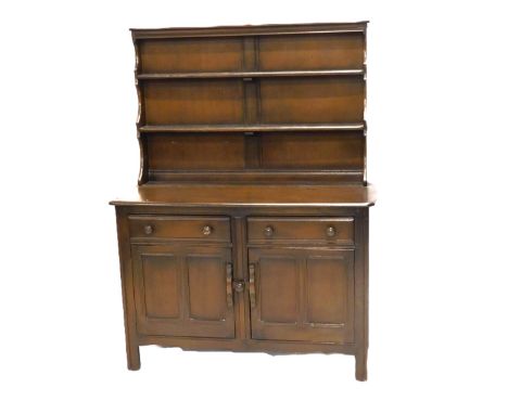 An Ercol dresser, the raised back with two plate shelves, the elm base with an arrangement of two drawers and two doors, on s