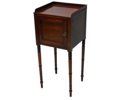 A 19thC mahogany pot cupboard, with a galleried top above a panelled door, on ring turned tapering legs, 84cm high, 38cm wide