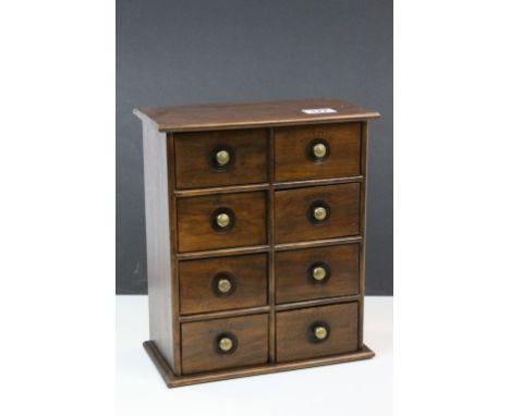 Vintage Teak Spice Cabinet comprising Eight Drawers with Brass Recessed Knob Handles, the drawers marked ' Cloves, Nutmeg, Di