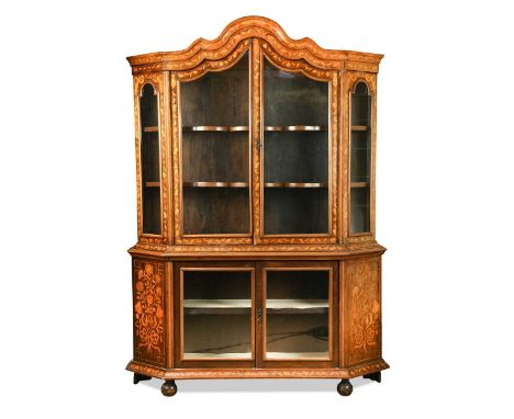 A Dutch marquetry glazed display cabinet, 19th century, inlaid all over with flowers, ribbons and classical urns, the arched 