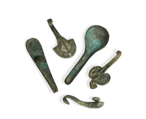 A group of four Chinese bronze belt hooks, Warring States -Han Dynasty, to include a silver inlaid example and a specimen wit