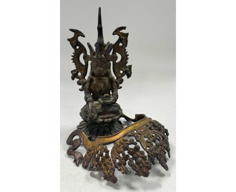 A Tibetan gilt metal deity tiara, 18th century, of openwork foliate design, whiplashed end ribbons, 13.5cm high; together wit