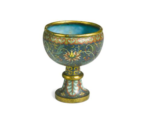 A Chinese cloisonné enamel and partly gilded pedestal goblet, Qing Dynasty, 18th century, the blue ground enriched with four 