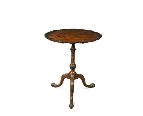 A Chippendale style mahogany tripod table, 19th century, the pie crust tilt-top over a Gothic carved and turned column, on ac