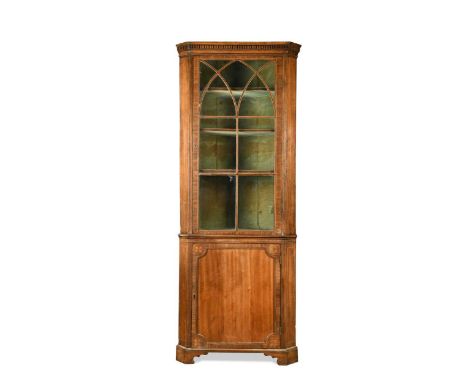 A George III mahogany floor standing corner cupboard, the glazed top section over a base with panelled door and bracket feet2
