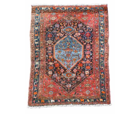 A Malayer rug, circa 1930, the central pale indigo lozenge within a deep indigo field of star and bird motifs216 x 136cmsuper