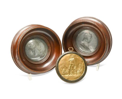 A pair of framed white metal medallions of Napoleon and Josephine, 19th century, respectively modelled in relief as Emperor a