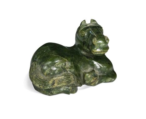 A Chinese carved spinach jade recumbent Horse in Ming style, 20th century, its head turned to the right9.5 x 15cm