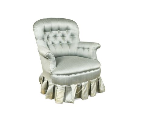 A beech framed button back nursing chair, 20th century, the curved back over outscrolling arms, raised on turned front legs a