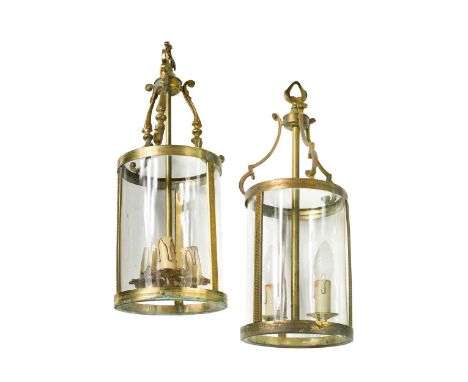 A near pair of cylindrical brass hall lanterns, early 20th century, each with C-scroll arms supporting a cylindrical body wit