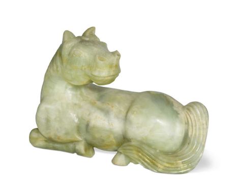 A Chinese carved jade-type stone Horse, in Ming style, 20th century, recumbent and turning its head to the rear17 x 25cm