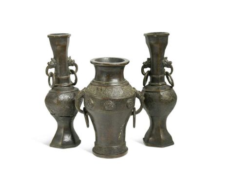 A pair of early Ming bronze hollow vases, of archaic style,  cast with lozenge trellis to the bodies, mask and ring handles t