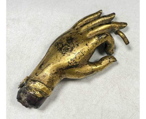 A Tibetan gilt bronze Buddha hand, heavily cast, 17th/18th century, 15 x 7cm