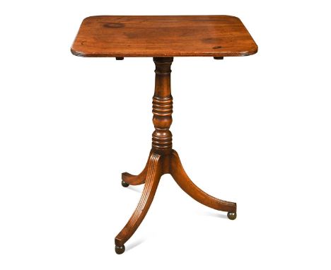 A Regency Cuban mahogany tilt-top lamp table, the rounded rectangular reeded top above a ring-turned column and reeded splay 