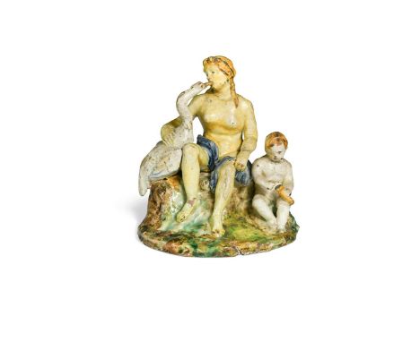 A Maiolica pottery figure of Leda and the swan, 18th century, Leda seated supporting the swan with cupid by her side23cm high