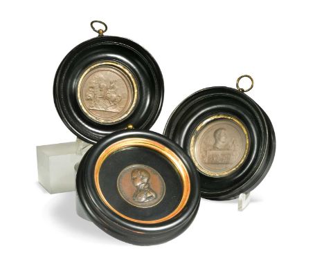 A group of three Napoleonic medallions, 19th century, the smallest in bronze and showing the boy Napoleon; the remaining two 