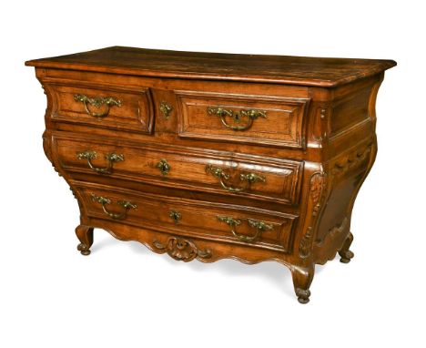 An Italian provincial carved commode, Venetian mid-18th century, of slight serpentine outline, the moulded top above two shor