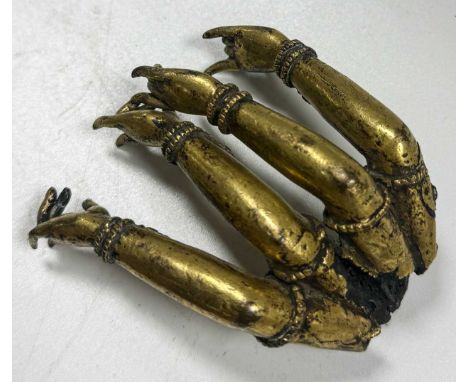 A Sino-Tibetan gilt bronze multi-armed Buddha limb fragment, 17th/18th century, 7 x 7cm