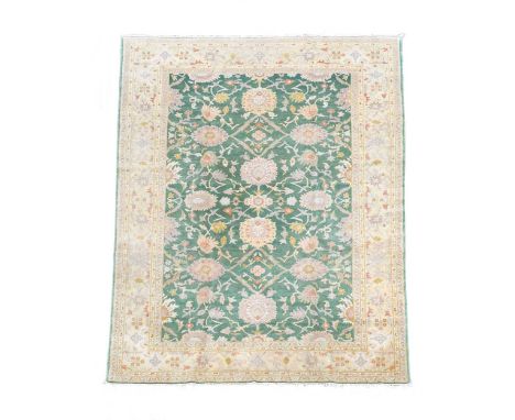 A Ziegler style carpet, late 20th century, the jade green field with a typical design of large-scale lotus flowers, within a 