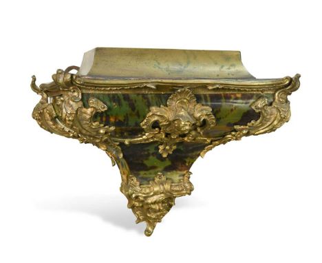 A French green stained tortoiseshell and ormolu clock bracket, 18th century, in Rococo style with Oriental male mask centre m
