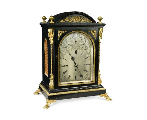 A Victorian ebonised and gilt metal mounted three train table clock with wall bracket, the engraved arched silvered dial (uns