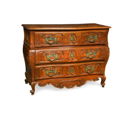 A Louis XV provincial walnut commode, of serpentine form, the three long drawers with incised carved scrolling outline with g